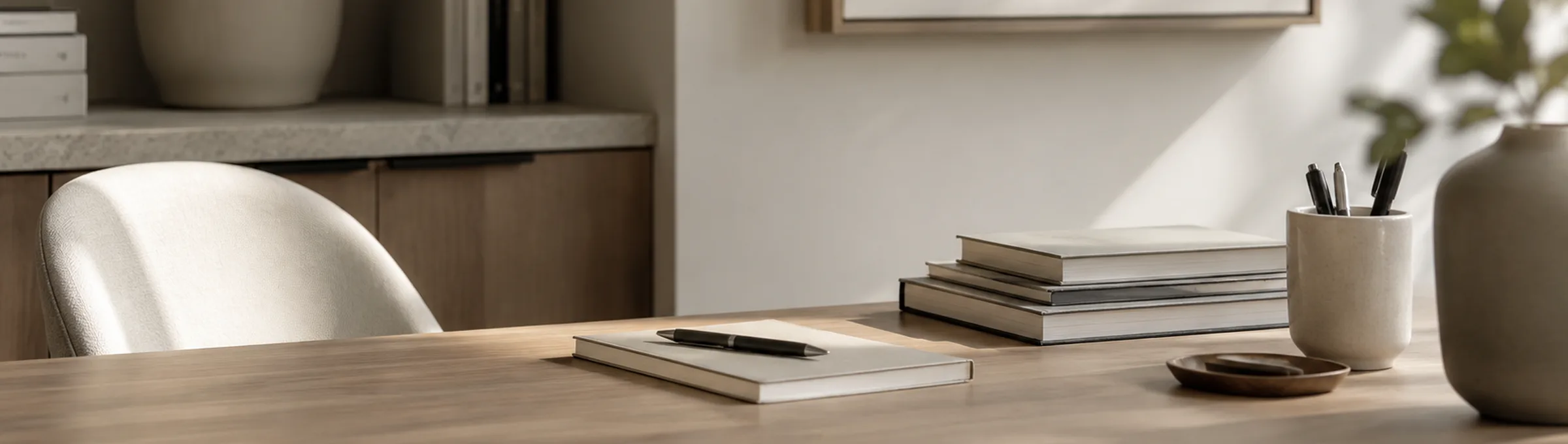 Consultation desk with a notebook, reference books, and framed artwork